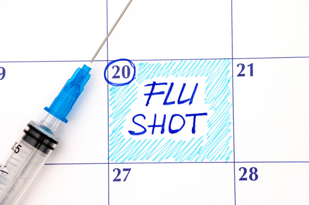 Reminder Flu Shot in calendar with syringe - Foto, immagini