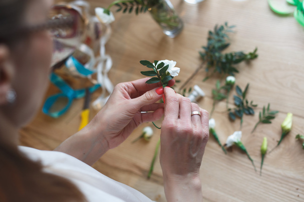 Florist at work: woman making floral composition of different flowers - Fotoğraf, Görsel