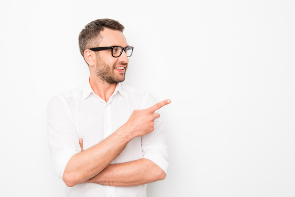 Cheerful happy bearded guy in glasses showing the direction - 写真・画像
