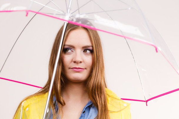 Woman wearing waterproof coat holding umbrella - Photo, Image