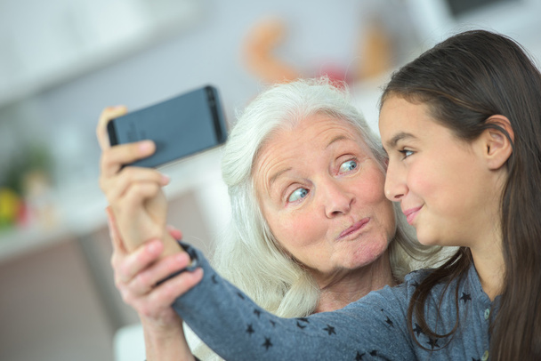 Grandma and girl taking a photo of themselves - Foto, Imagen