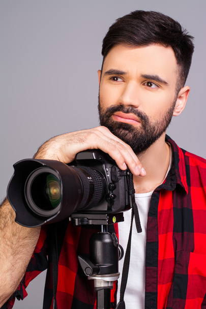 Portrait of sad man with camera thinking about photo concept - Photo, Image