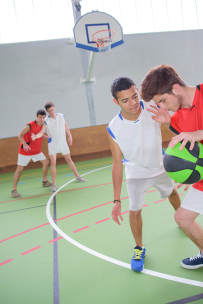 teens playing basketball and man - Foto, immagini