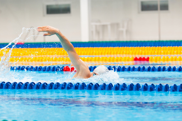 Man swimmer swimming crawl in blue water. - Фото, зображення