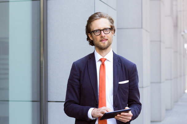 Freelance man in business suit with tablet PC. - 写真・画像