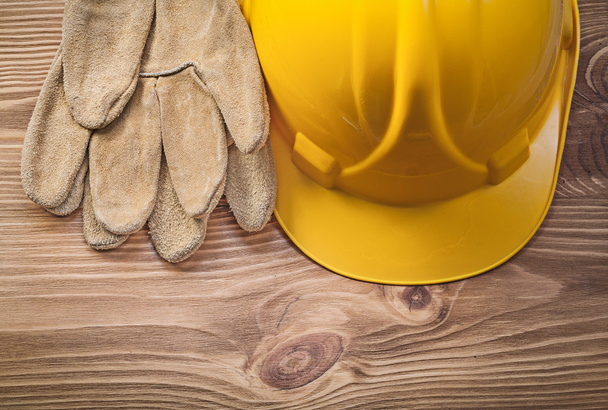 Hard hat leather safety gloves on wood board construction concep - Foto, Imagen