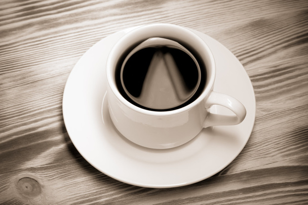 White cup of coffee on new wooden table. Toned - Photo, Image