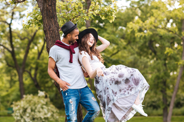 Couple standing and laughing outdoors - Photo, Image