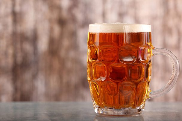 Pint of beer on wooden background with space for text - 写真・画像