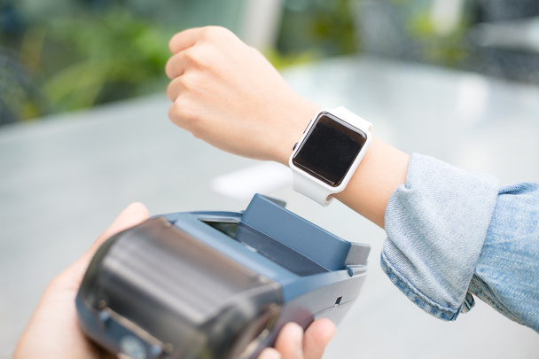 Woman paying the bill by smart watch  - Foto, immagini