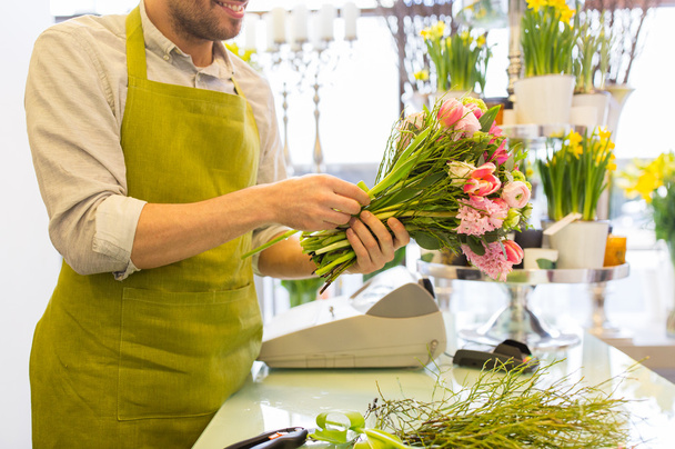 close up of florist man with bunch at flower shop - Foto, afbeelding