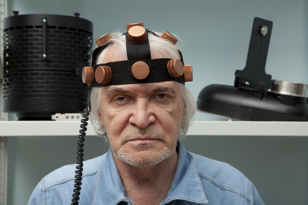 Man crazy inventor wearing a helmet brain research - Photo, Image