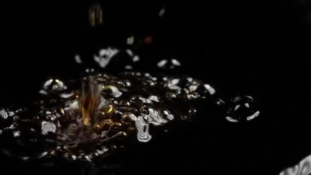 Super slow motion low light macro video of drops falling in cola - Кадри, відео