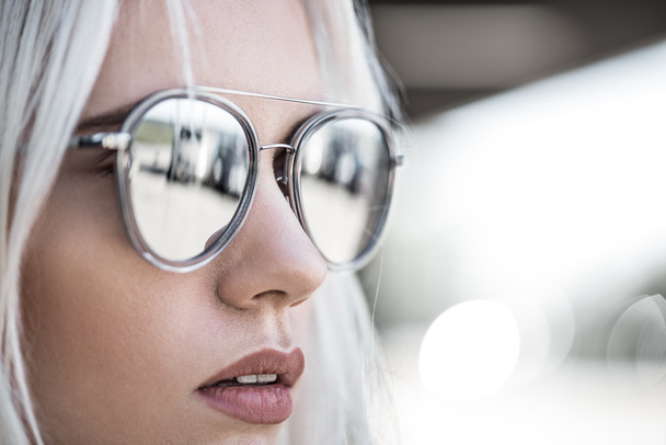 Beautiful blonde girl in grey sunglassses outdoor - Photo, Image