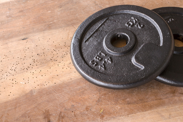 Weights and dumbbell set for fitness  on a wooden background - Foto, Imagen