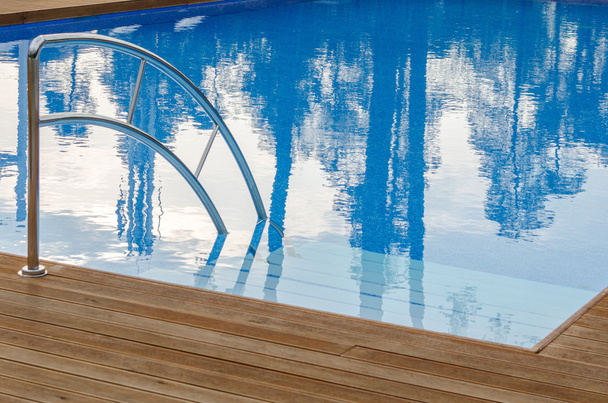 Swimming pool and wooden deck - Photo, Image