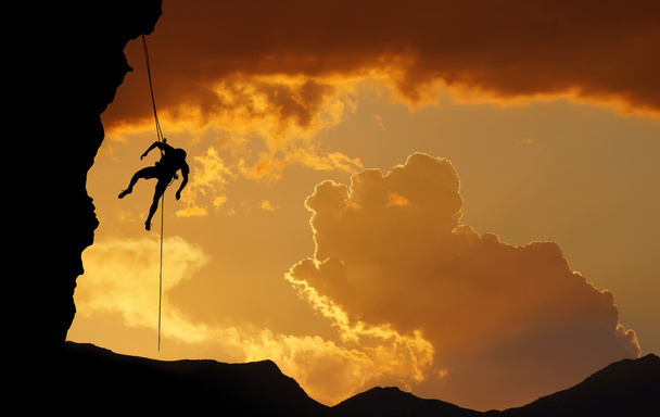 Silhouette of Rock Climber at Sunset - Photo, Image