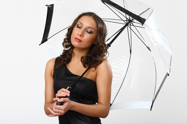 Portrait of young woman with umbrella - Fotó, kép