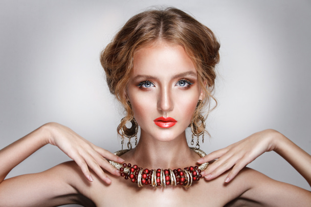 blond hair beauty woman portrait wears golden ear-rings and necklace - Zdjęcie, obraz