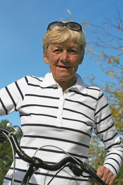 Sixty five year old lady on her bike - Photo, Image