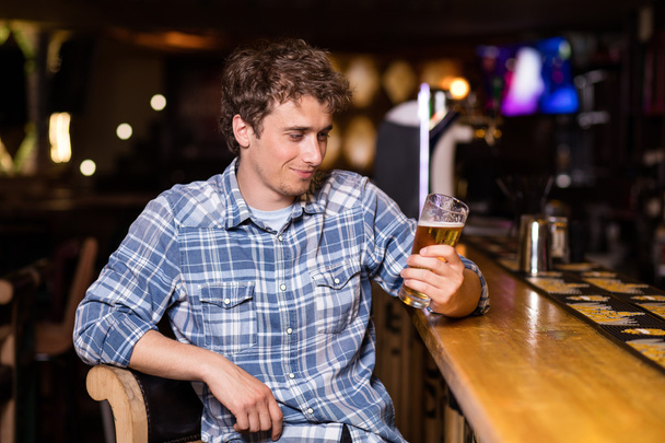 single man sitting at bar having a beer - Фото, изображение