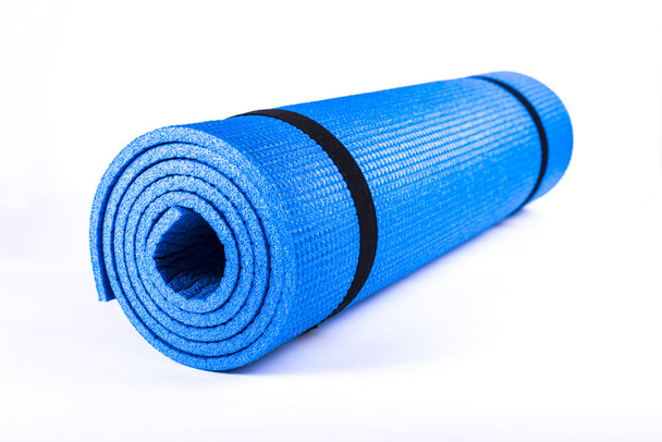 Isolated on white background yoga blue mat. - Zdjęcie, obraz