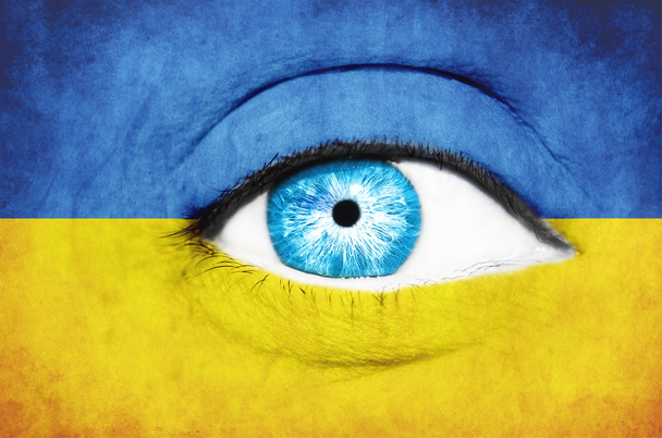 Woman face painted with flag of Ukraine - Foto, Imagen