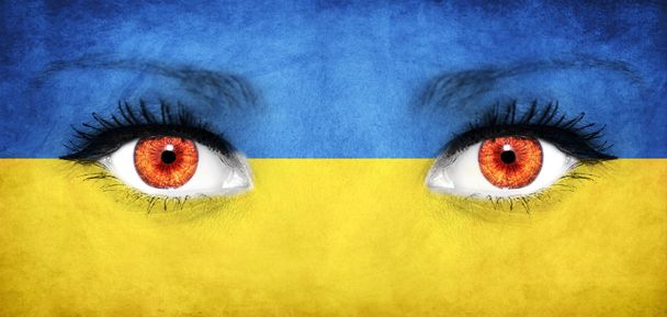 Woman face painted with flag of Ukraine - Foto, Bild