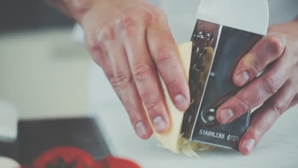 The cook rubs cheese on a grater - Video, Çekim