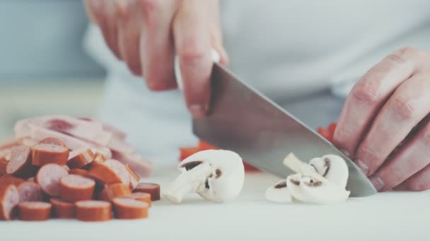 Chef cutting mushrooms for pizza in a restaurant - Felvétel, videó