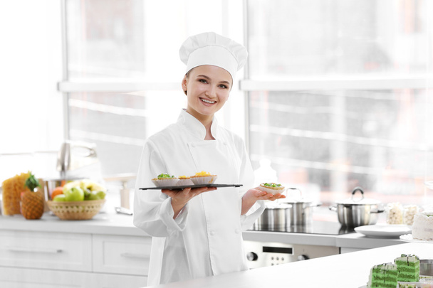 Female chef working at kitchen - 写真・画像
