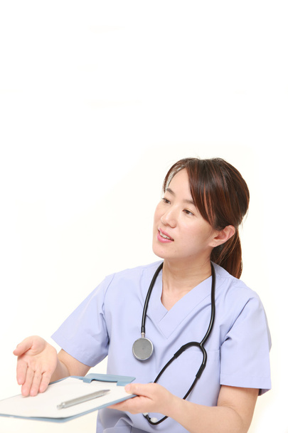 Japanese female doctor with medical interview sheet - Foto, Imagen