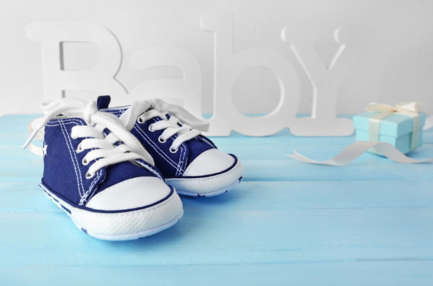 Baby boots on blue floor - Фото, изображение