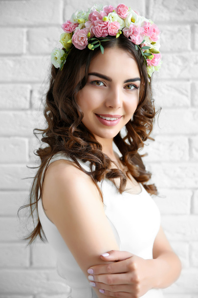 Beautiful young woman with flowers - Фото, зображення