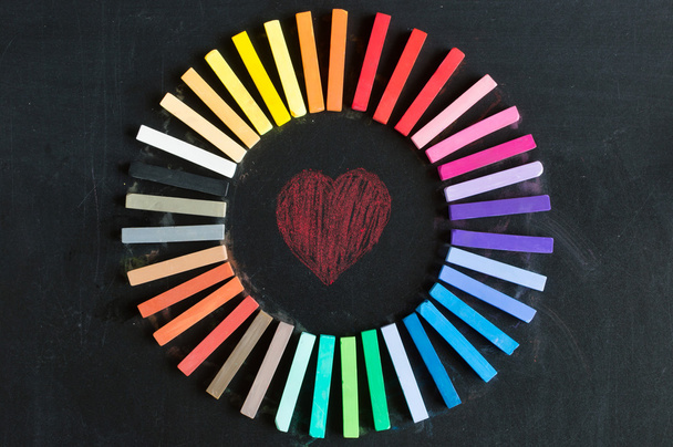 Colorful chalks lined up rounded on circle - Photo, Image