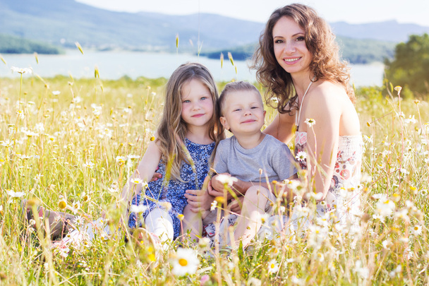 Mother outdoors with son and daughter - Foto, afbeelding