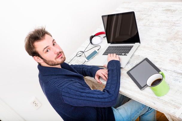 A young man working online in the home office	 - Фото, изображение