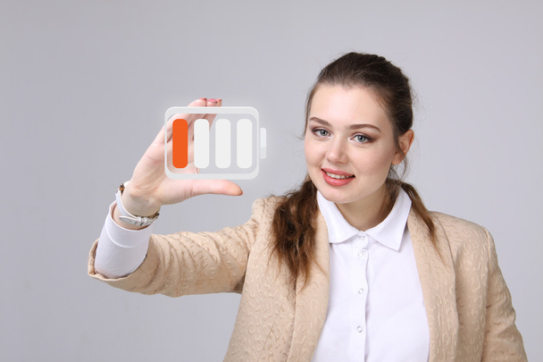 Young Businesswoman and battery level icon - Foto, Imagem