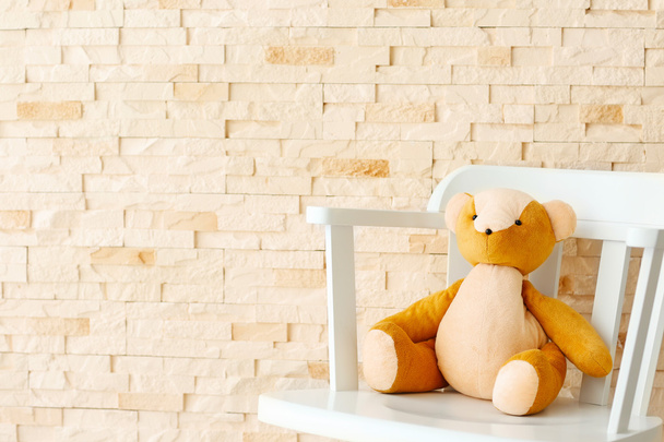 Baby toy on brick wall   - Foto, afbeelding