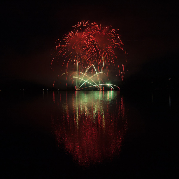 Colorful fireworks with reflection on lake. - Photo, Image