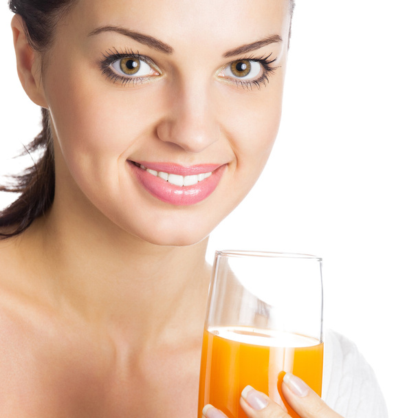Girl with glass of orange juice, on white - Фото, изображение
