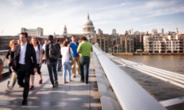 Blurred background of crowd of people on millennium bridge and st pauls cathedral in background, london - Photo, Image