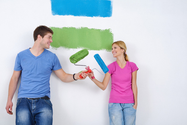 Happy couple paint wall at new home - Photo, image