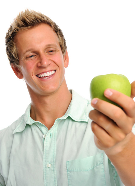 Handsome young man holding an apple - Foto, imagen