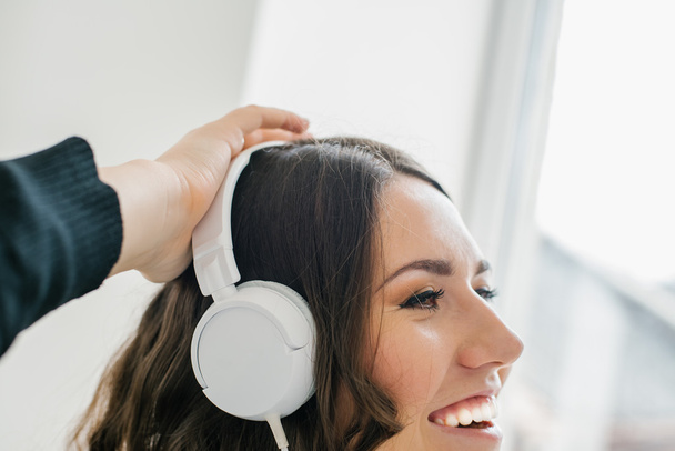 beautiful brunette girl listening to music on headphones white - Foto, imagen