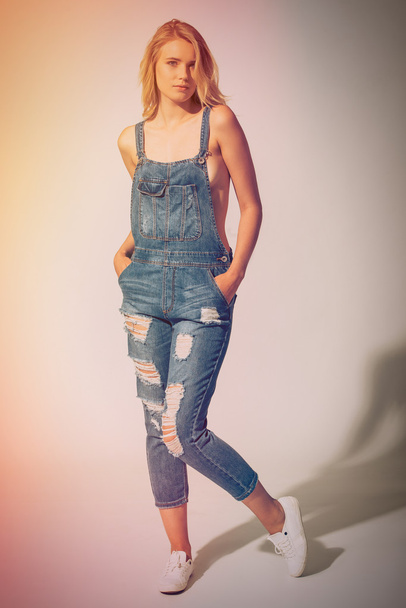 young woman in jeans overalls - Fotó, kép