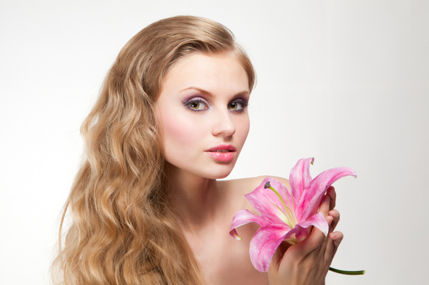 Young woman with pink lily - Photo, Image