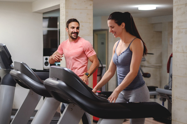 Man and woman laughing on treadmill - Photo, Image
