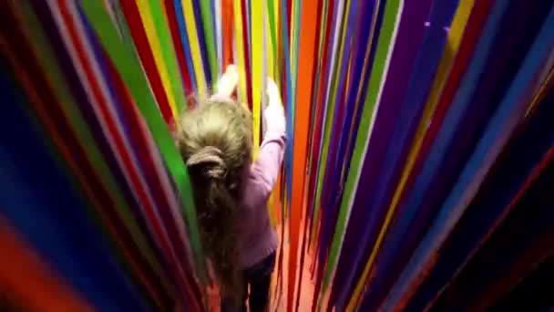 Little girl wades through ribbons - Кадры, видео