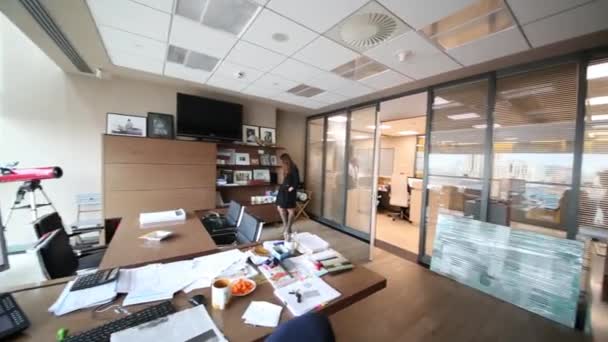 Young woman stands in modern office  - Video
